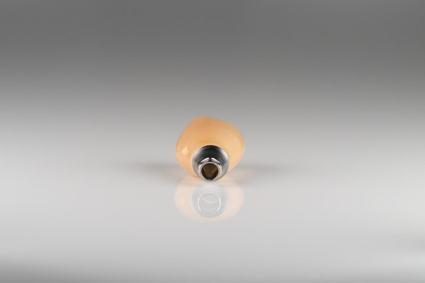 Crown is milled, sintered, stained, glazed, and cemented to the Ti base 3